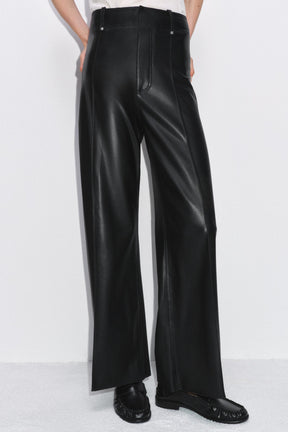 Tailored wide-leg leather-effect trousers.
