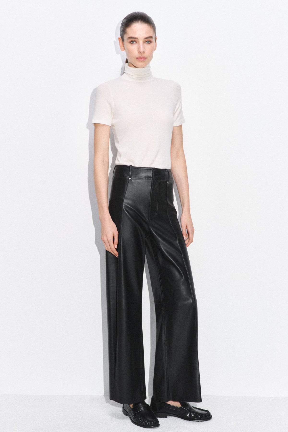 Tailored wide-leg leather-effect trousers.