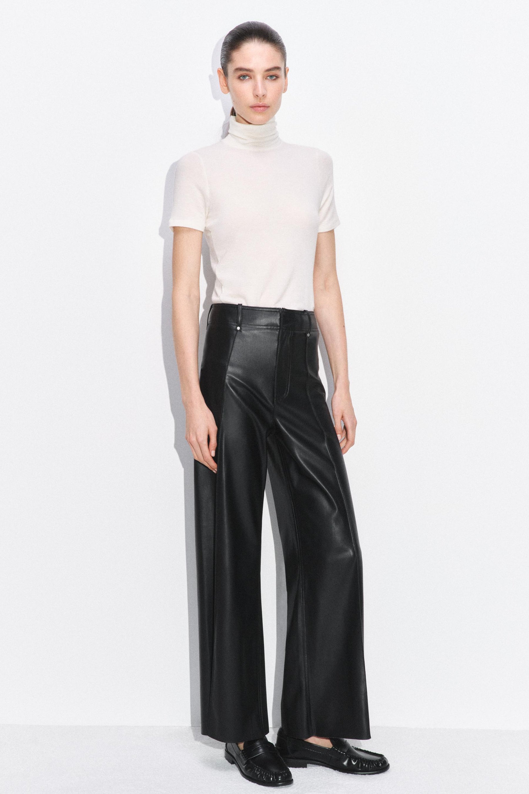 Tailored wide-leg leather-effect trousers.