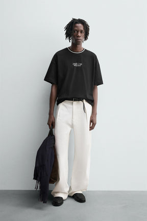 T-SHIRT WITH RAISED SLOGAN PRINTS - Image 1