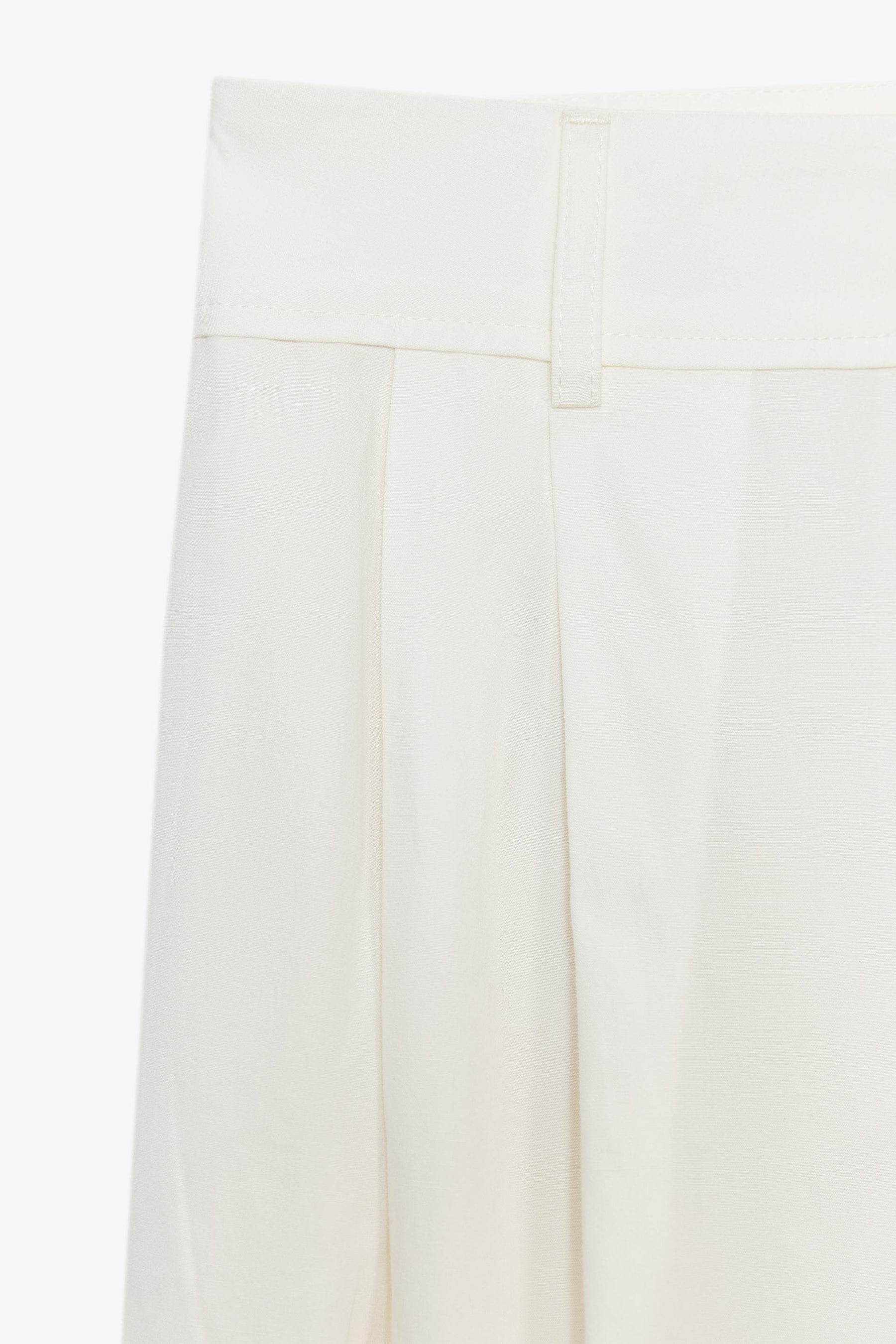 PLEATED TROUSERS WITH FLAPS