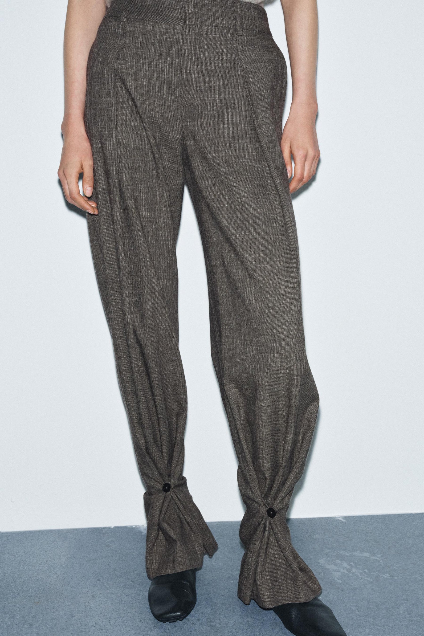 Trousers with button cuff