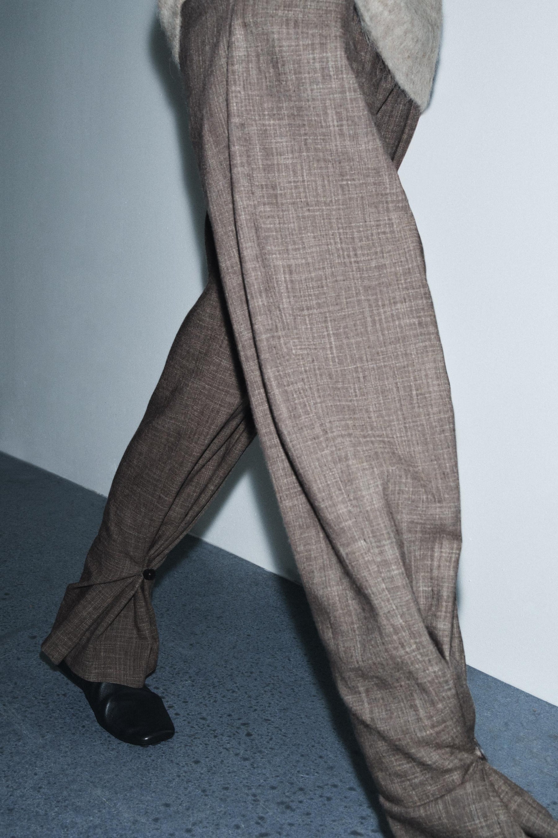 Trousers with button cuff
