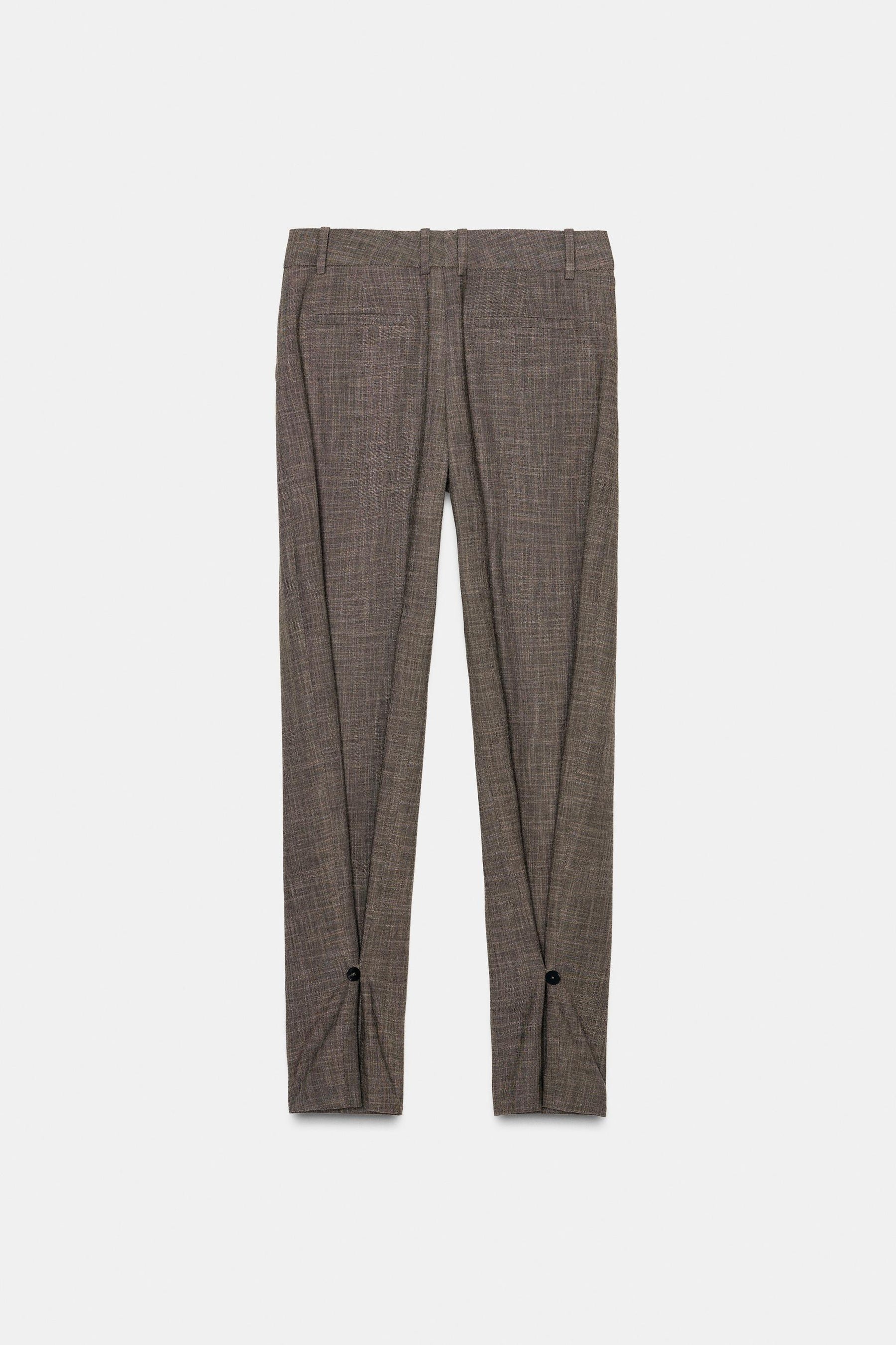 Trousers with button cuff