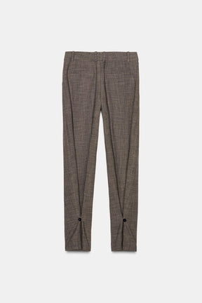 Trousers with button cuff
